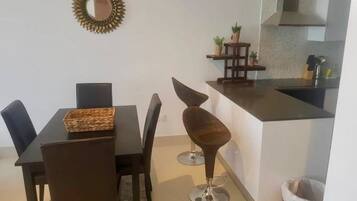 Family Apartment, 3 Bedrooms, Kitchen, Pool View | In-room dining
