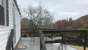 A wooden deck with steps leading to a house. - Book longer and save weekly plus monthly discounts (Hayesville)