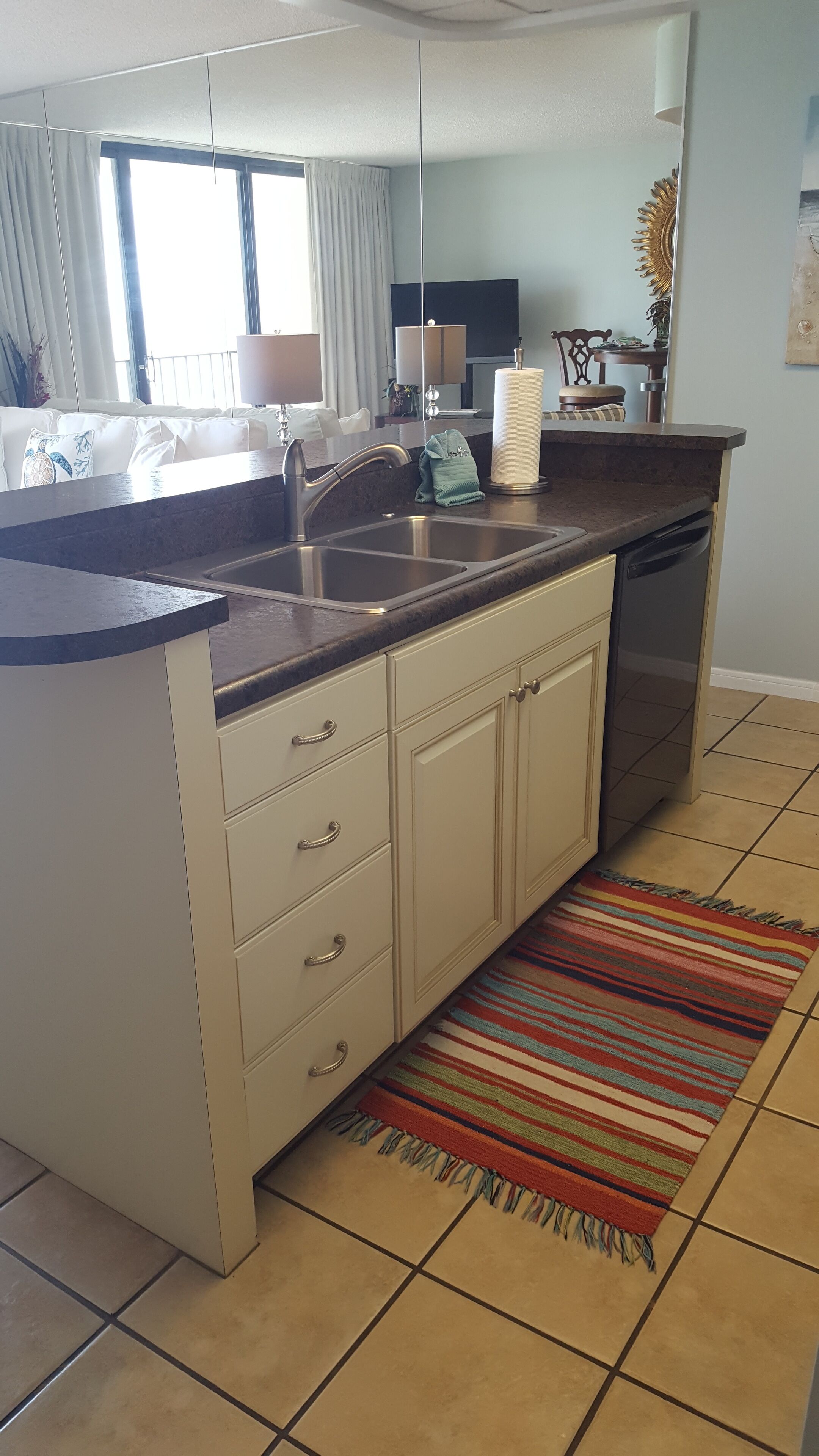 A modern kitchen with a built-in dishwasher, a sink, and a countertop.