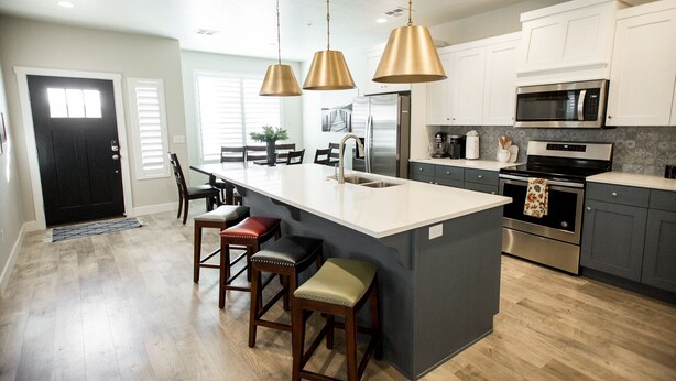 A modern kitchen with a central island, stainless steel appliances, and pendant lighting. - ❀Aloha❀ - Tropical Island Retreat | POOL IS OPEN!!! Great Family Friendly Vacation! (Washington)