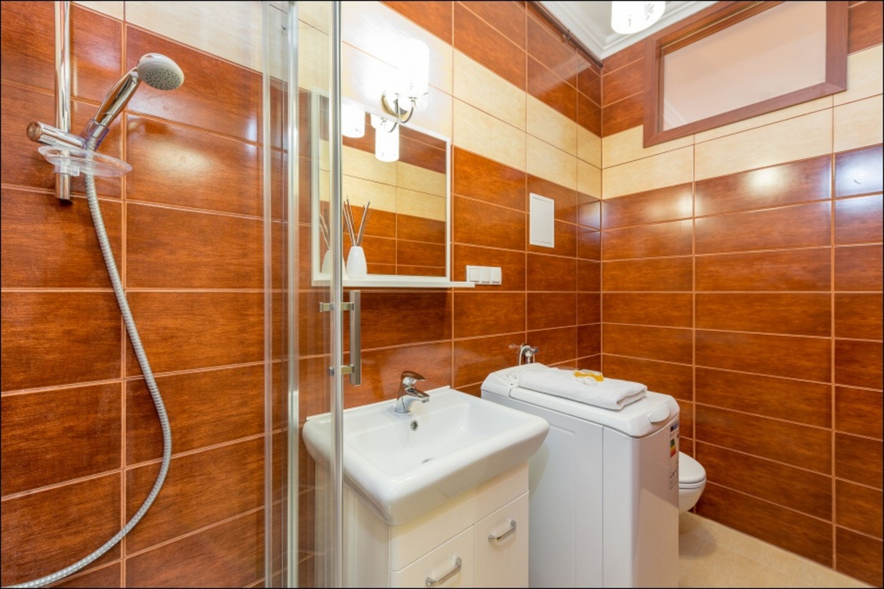A bathroom with a shower, sink, and toilet.