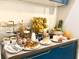 A breakfast buffet with various food items and condiments.