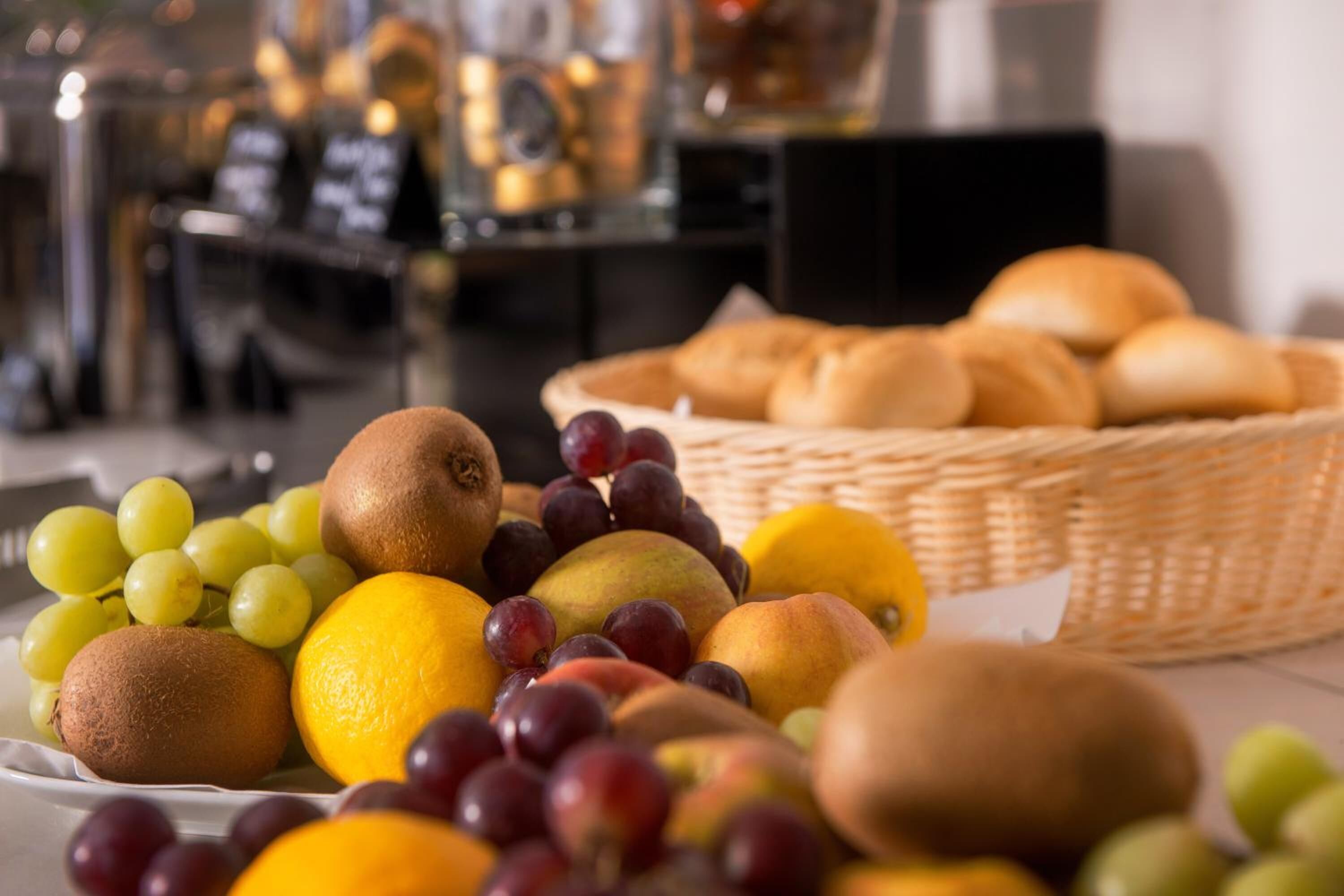 A variety of fruits and bread on a table.