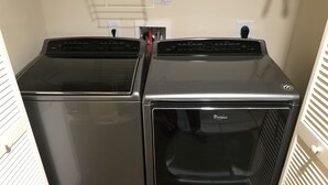 Two stacked Whirlpool dryers in a laundry room with a white vented door on the right. - THANK YOU 2025 RENTERS for 100%. 2026 only 3 weeks left DIRECT OCEAN FRONT 5BR  (Myrtle Beach)
