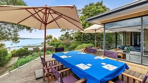 Enjoy al fresco dining with a view of the sea and lush surroundings.