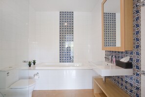A bathroom with a bathtub, a toilet, and a sink. - Four Kings 3 (Anglesea)