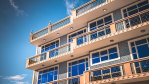 A multi-story building with balconies and large windows. - Abuharee Grand (Hithadhoo)