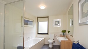 Ein Badezimmer mit Duschkabine, Badewanne, Toilette und Waschbecken.