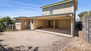 A two-story building with a covered patio area. - Beach View (Fairhaven)
