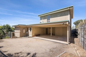 A two-story building with a covered patio area. - Beach View (Fairhaven)
