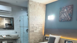 A modern hotel room with two beds, a bathroom, and a small kitchenette. - ILLUSION XPRESS Downtown Playa (Playa del Carmen)