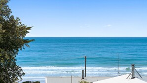 A coastal view with a clear sky, a calm sea, and a metal structure with antennas. - Casino Views (Apollo Bay)
