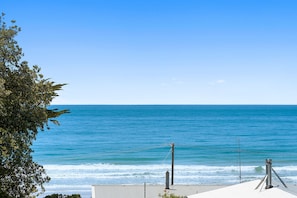 A coastal view with a clear sky, a calm sea, and a metal structure with antennas. - Casino Views (Apollo Bay)