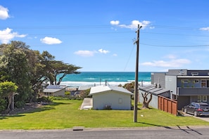A coastal residential area with houses, a view of the ocean, and a clear sky. - Casino Views (Apollo Bay)