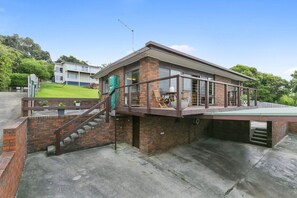 A brick building with a covered outdoor area, a staircase, and a green fence. - 1 at Fifty Nine  Beach Classic  in Lorne (Lorne)