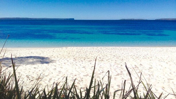 A beach with white sand and clear blue water. - On Collingwood Beach  by Book Jervis Bay - Upstairs Apartment (Vincentia)
