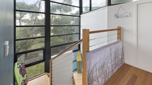 Staircase leads to an upper level with a view of the surrounding landscape.