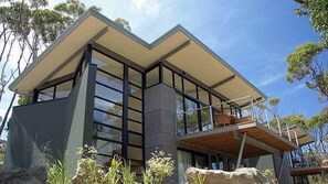 Enjoy panoramic views from the spacious balcony with comfortable outdoor seating.