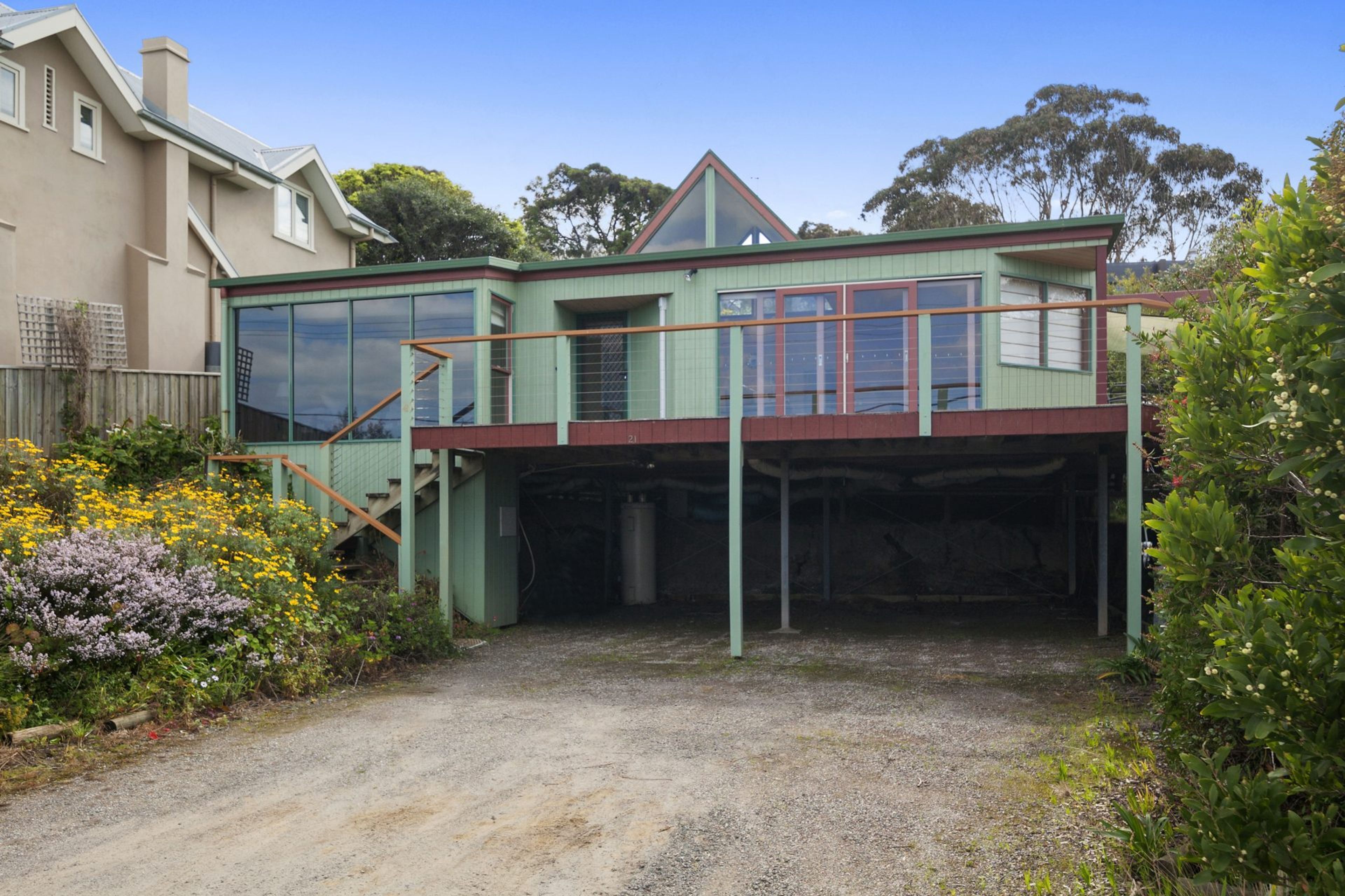 A two-story house with a covered garage and a front porch.