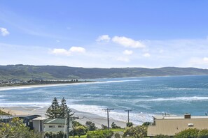 A coastal view with a beach, ocean, and hills in the distance. - Coleridge (Marengo)