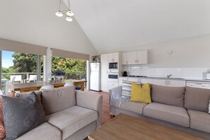 A modern kitchen with white cabinets, a built-in oven, and a microwave. - Coleridge (Marengo)