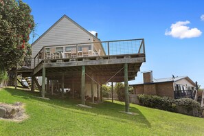 A two-story house with a balcony and a covered patio area. - Coleridge (Marengo)