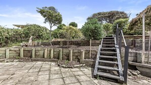 A wooden staircase leading up to a wooden deck with a stone pathway. - Absolute Beachfront Views Apollo Bay (Apollo Bay)