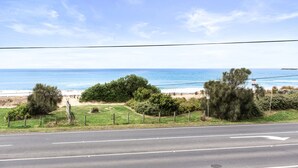 A coastal road with a beach view, a clear sky, and a sign indicating no parking. - Absolute Beachfront Views Apollo Bay (Apollo Bay)