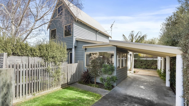 A residential property with a detached garage, a covered porch, and a well-maintained lawn. - Sea Loft (Apollo Bay)