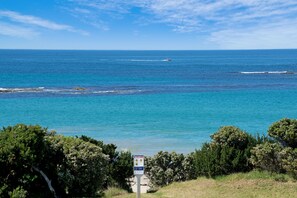 A coastal view with a signpost in the foreground, a boat on the water, and a clear sky. - Callahan (Marengo)