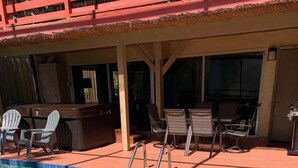 A clear swimming pool with a blue tiled edge, surrounded by lounge chairs and a covered patio area. - Beautiful 2BR 2BA Home with Private Pool & Jacuzzi - Includes Pool Table (Sarasota)