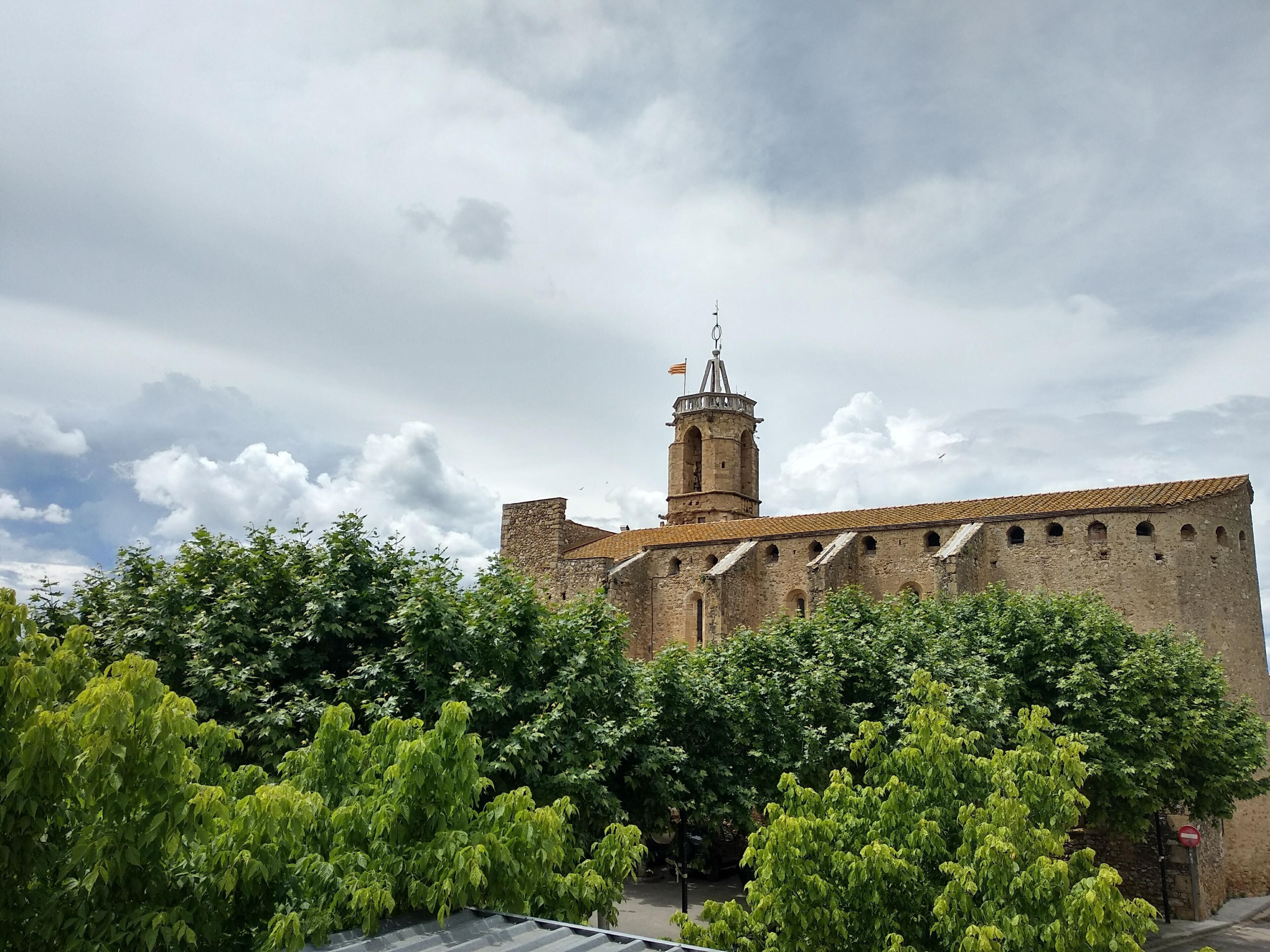 A historic building with a prominent tower and a flag atop.