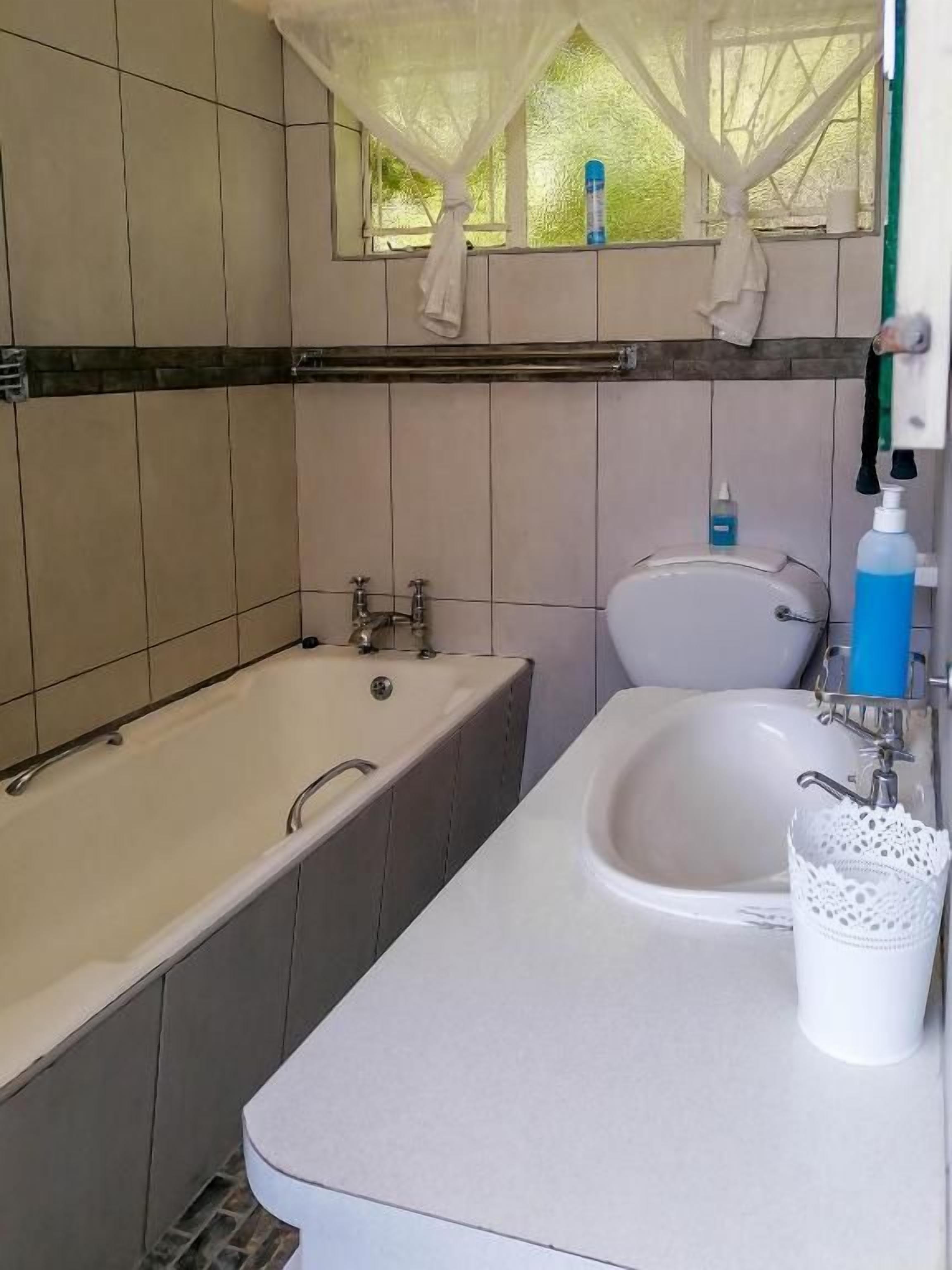 A bathroom with a bathtub, a sink, and a toilet.