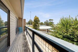 A balcony with a view of a park and a building in the distance. - Bayview Number Four (Lorne)