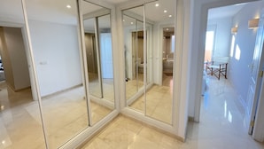 A spacious room with a large sliding glass door leading to a bathroom. The room has a tiled floor and a visible ceiling with recessed lighting. - ⭐ DREAM SEA VIEW PENTHOUSE - LUXURIOUS 3 BEDROOMS ⭐ (Calahonda)