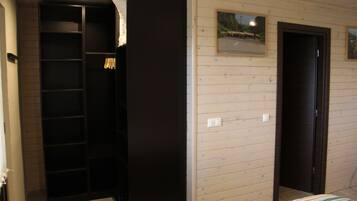 Ein Schlafzimmer mit Bett, Kleiderschrank und Tür.