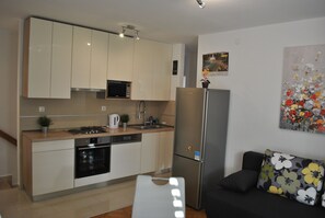 Apartment, 1 Bedroom | Private kitchen | Fridge, stovetop, electric kettle, cookware/dishes/utensils