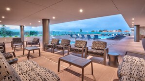 A rooftop pool area with lounge chairs and tables, a clear view of the sky, and a pool in the background. - Hampton Inn  & Suites Anaheim Resort Convention Center (Anaheim)