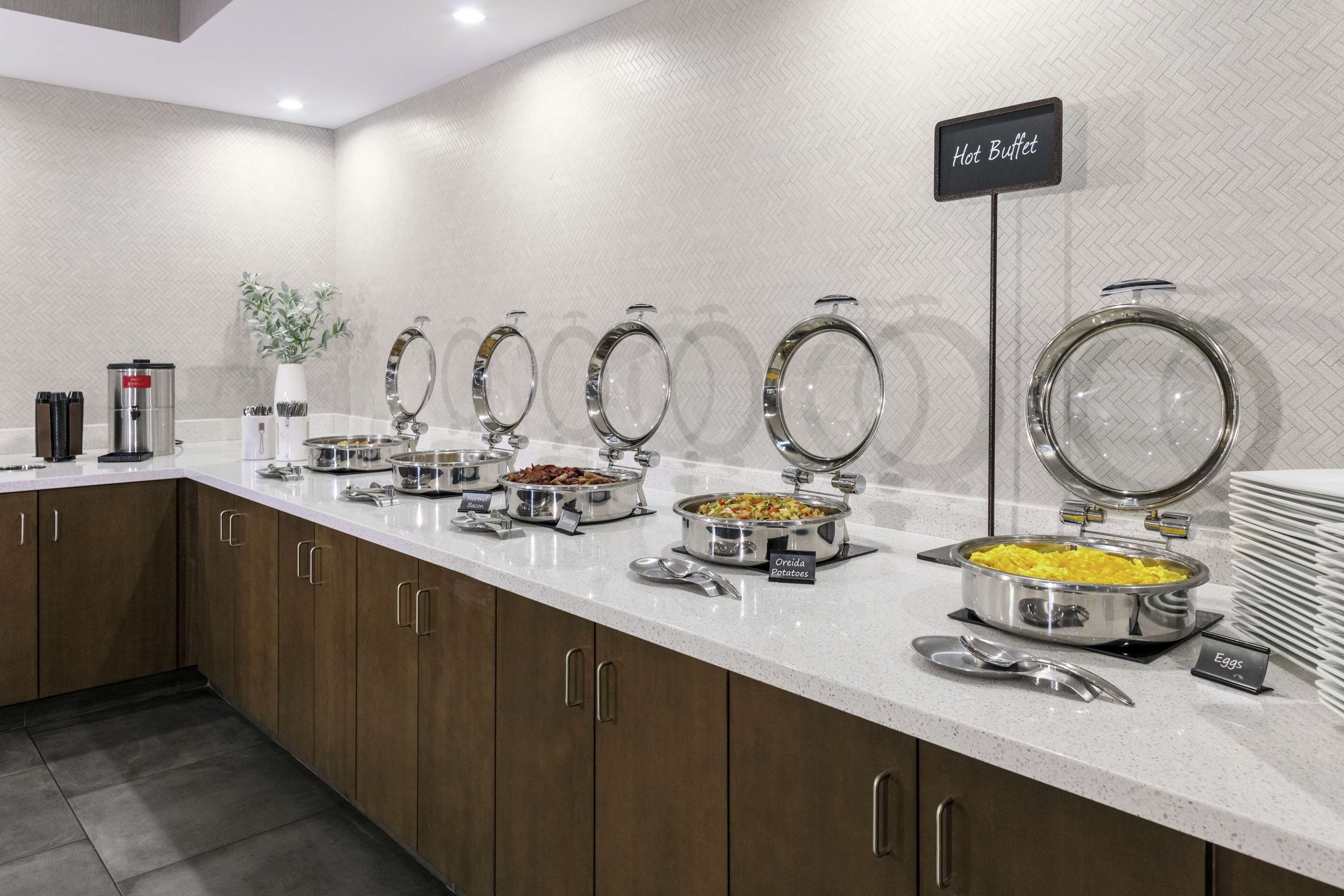 A buffet setup with labeled hot and cold food stations, including a sign for 'Hot Buffet'.