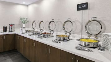 A buffet setup with labeled hot and cold food stations, including a sign for 'Hot Buffet'.