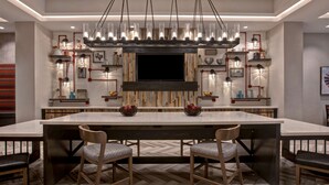 A modern kitchen with a large island, pendant lighting, and built-in appliances. - Home2 Suites by Hilton San Antonio Riverwalk, TX (San Antonio)