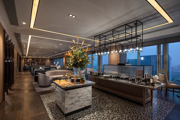 A modern kitchen with a marble island, large windows, and a city view. - Hilton Taizhou (Taizhou)