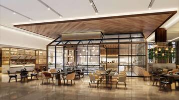 A spacious restaurant with high ceilings, modern lighting, and a variety of seating arrangements.