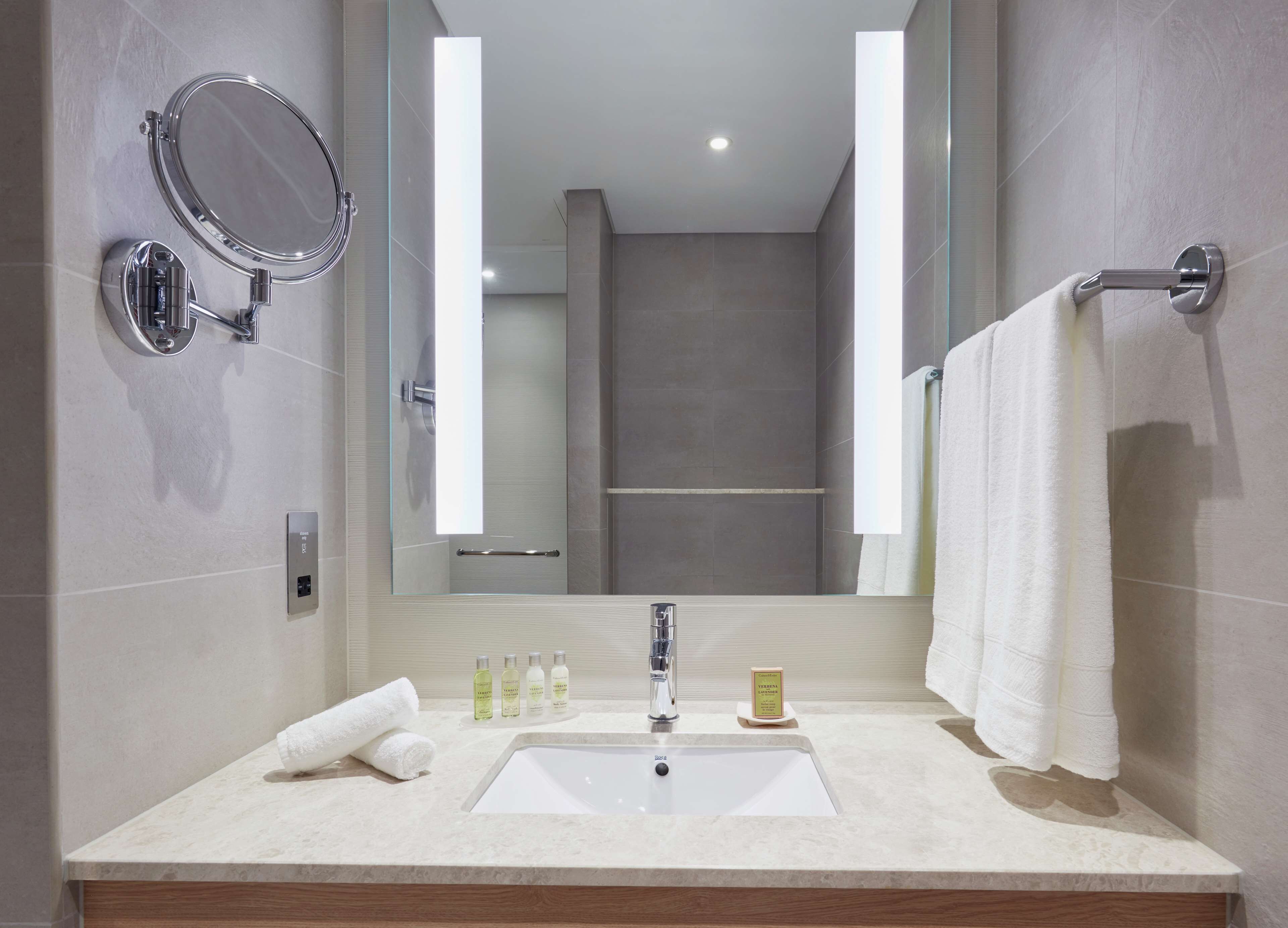 designer toiletries, hair dryer, towels