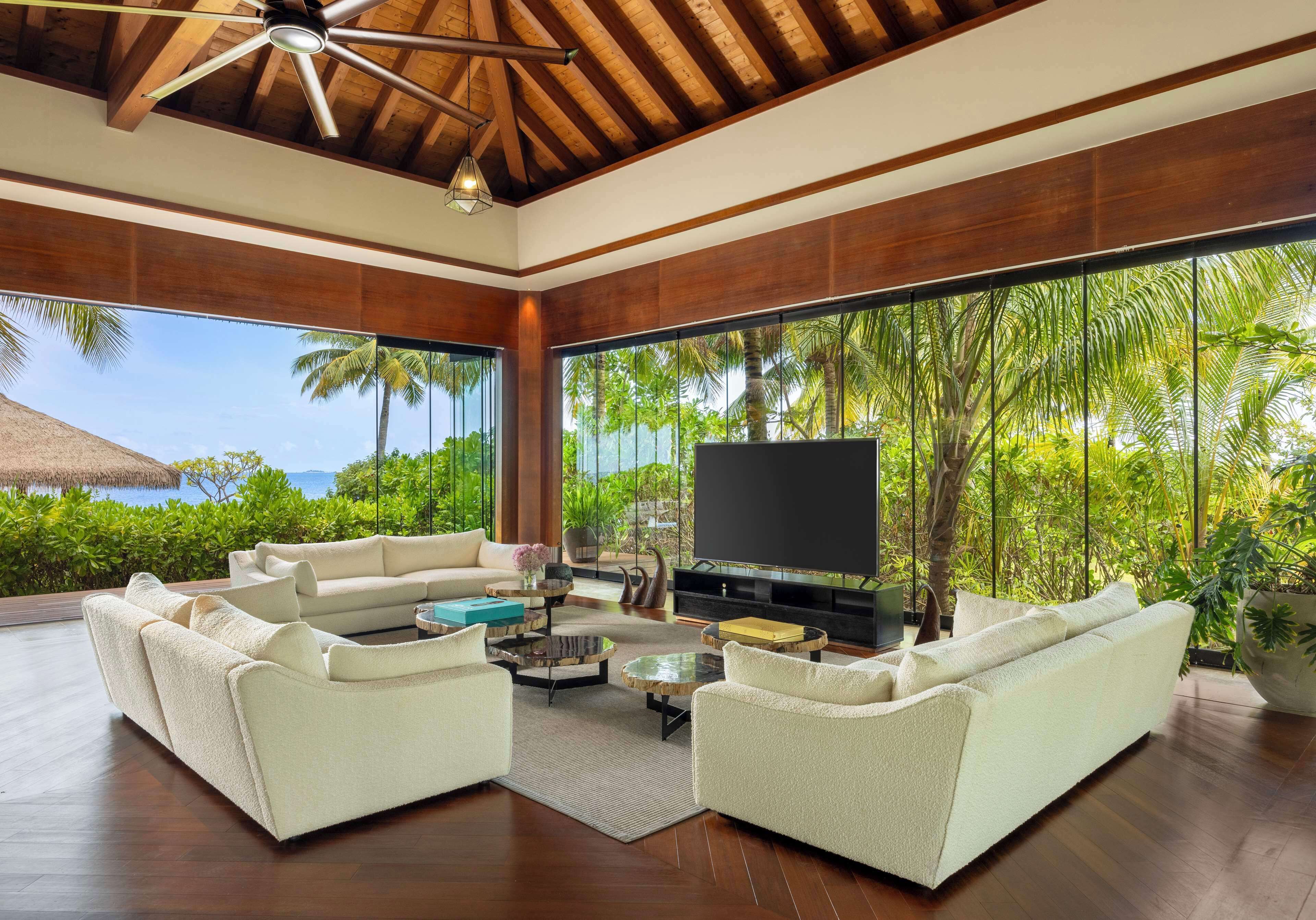 ithaafushi private island | living area | 65-inch flat-screen tv with cable channels, tv