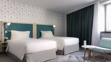 Ropa de cama hipoalergénica y caja de seguridad en la habitación