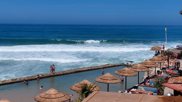 A coastal resort with a swimming pool, beach umbrellas, and ocean views. - Atlantic view house/front of the sea, private pool, Azenhas do Mar beach by walk (Colares)