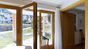 Enjoy the serene view from your outdoor space, featuring a large sliding glass door and a comfortable seating area.