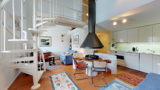 A modern kitchen with white cabinets and a built-in oven. - Spacious and quiet 2-room apartment on two floors, 45m2, facing north. (Sils/Segl Maria)