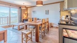 A modern kitchen with a built-in stove, a coffee machine, and a refrigerator. - Ski-in/ski-out apartment, 2 bedrooms, covered parking included (Les Arcs 1800)